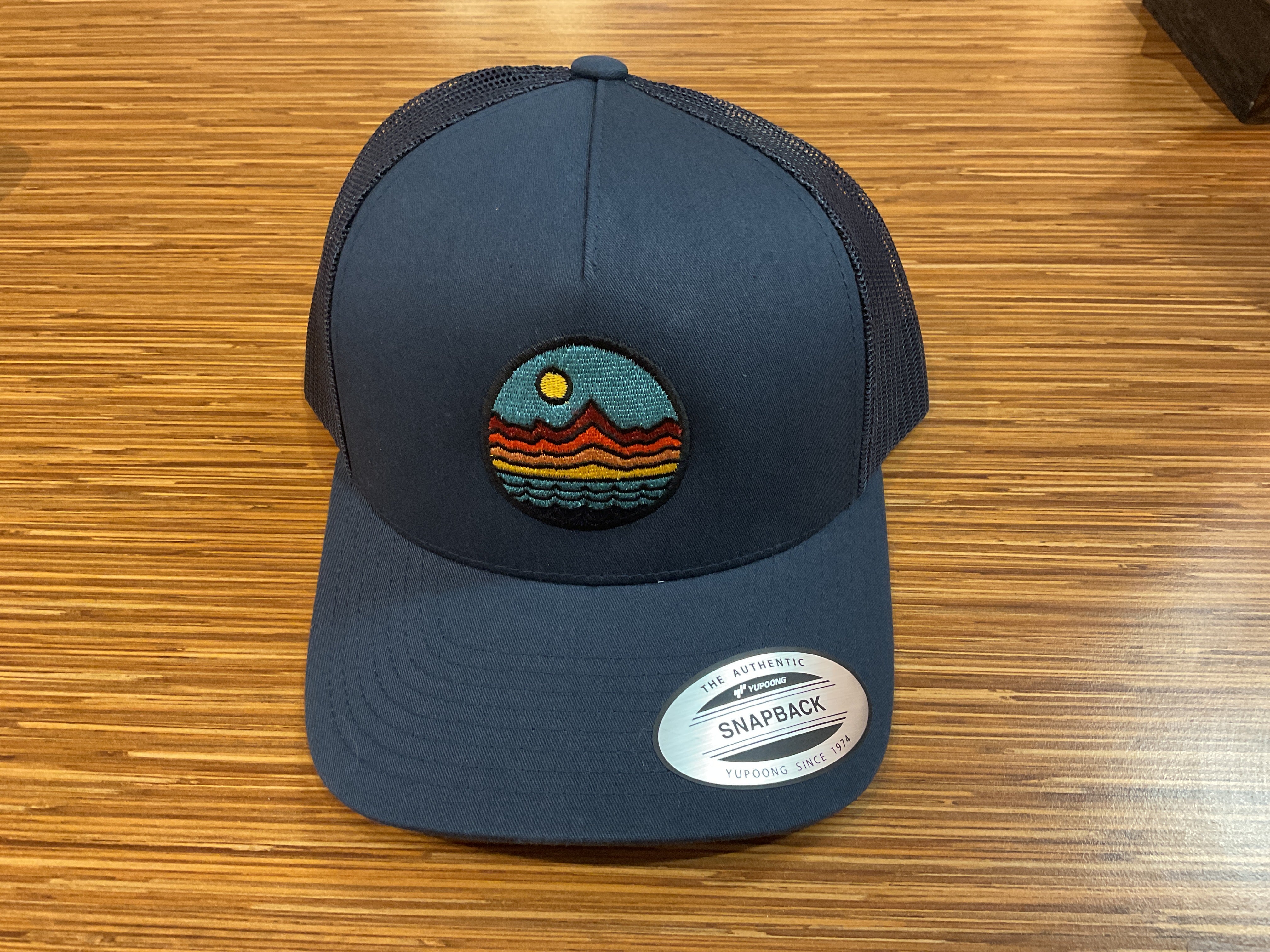Sunset Mountain Water Navy Trucker Cap