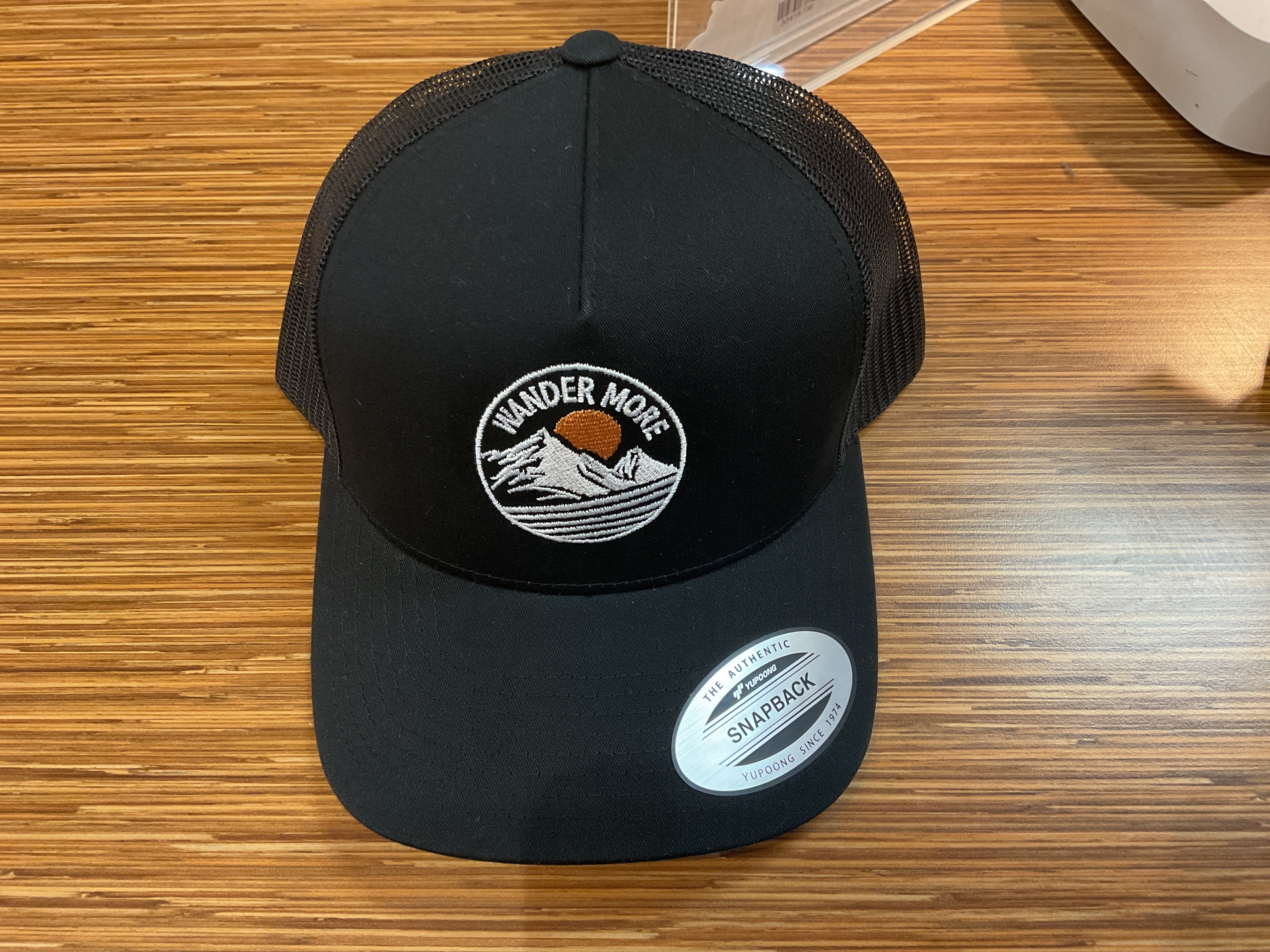 Wander More Black Trucker Cap